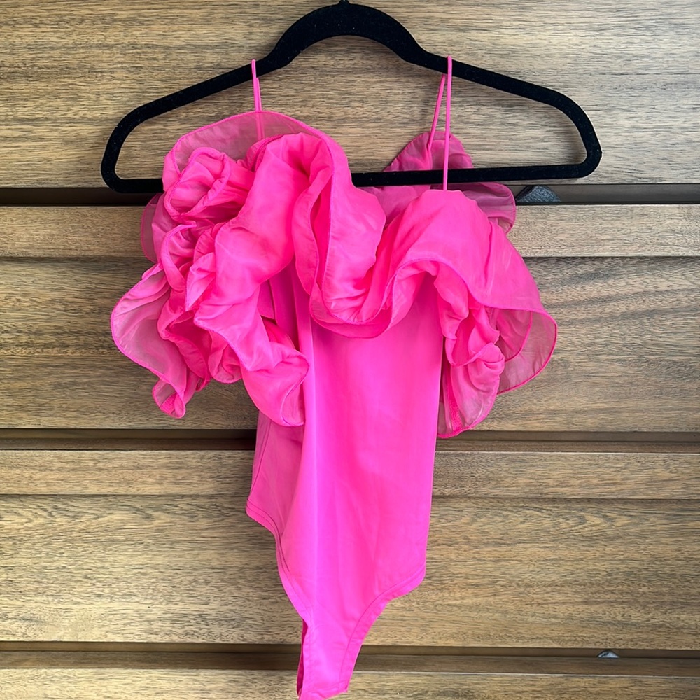 Pink, spaghetti trap body suit with off-the-shoulder ruffles.